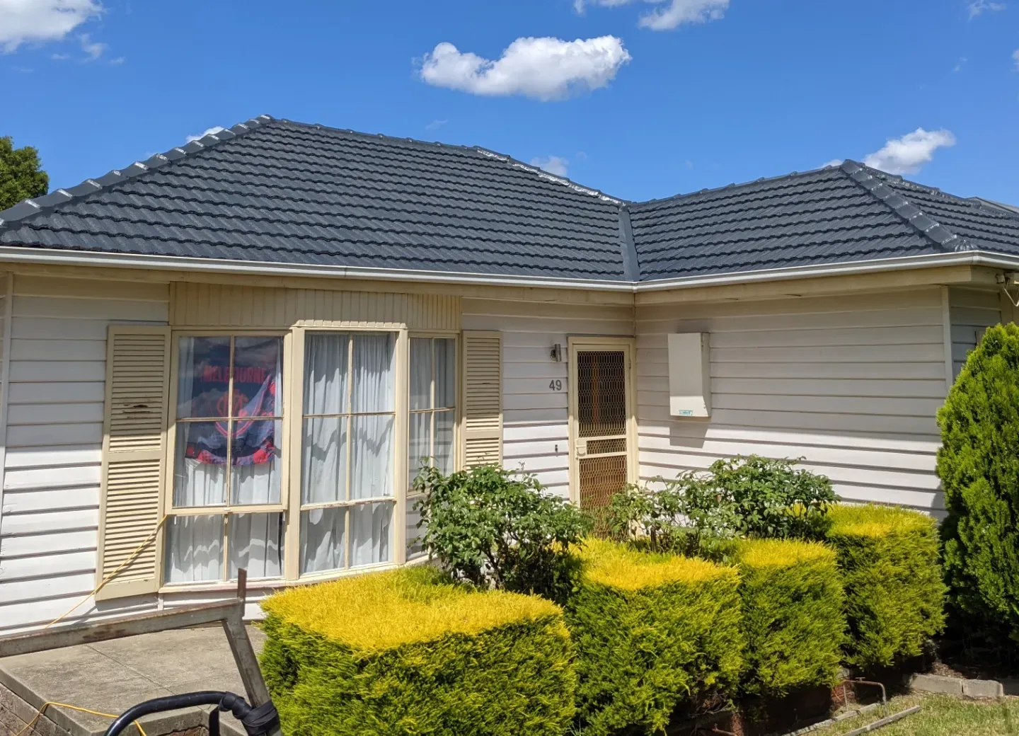 Weatherboard home with a hipped tile roof that Assured Roofing restored in Essendon, previewing your selected Colorbond colour